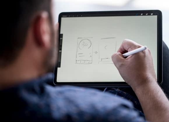 Design2-Services designer working on an ipad